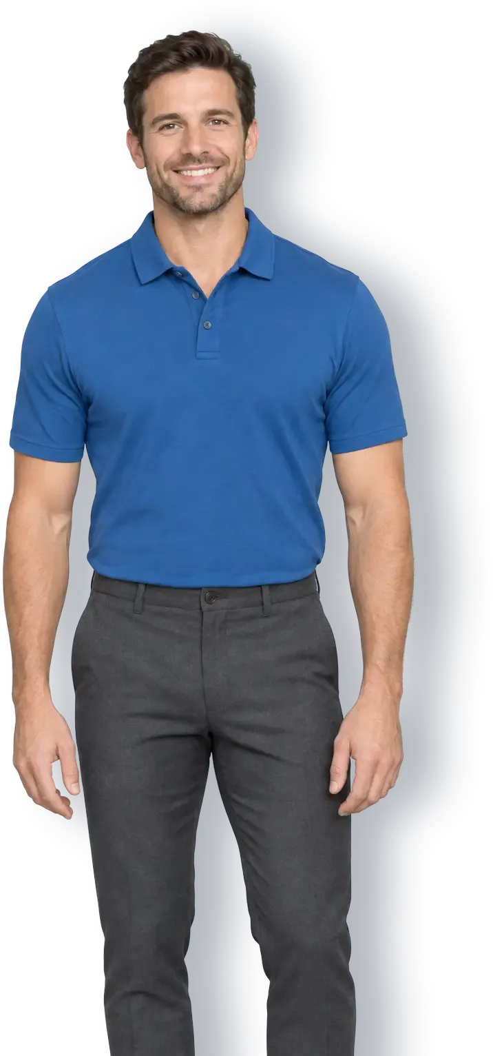 Smiling man with short brown hair wearing a blue polo shirt and charcoal trousers against a gray backdrop.